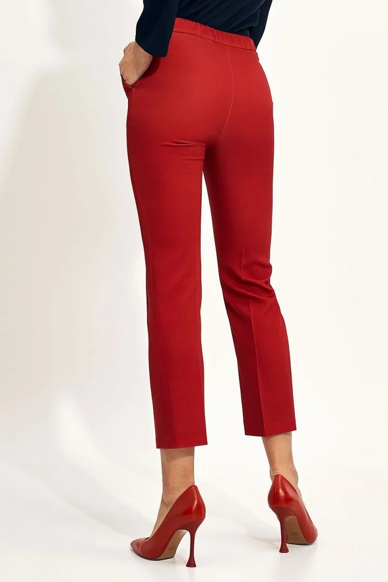 Red cropped pants with a regular fit, shown from the back with red high heels.