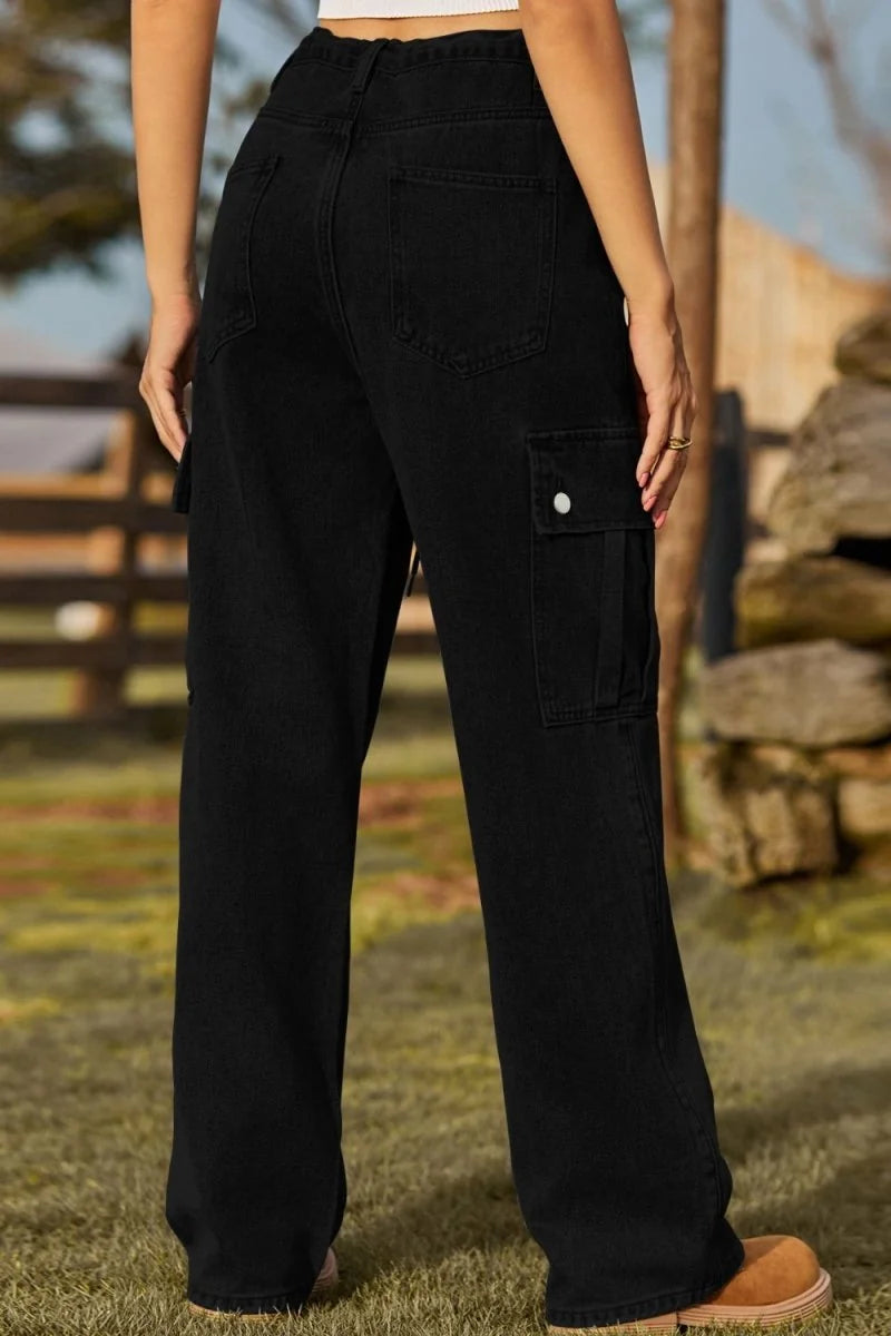 Black denim cargo pants with a regular fit, featuring a large cargo pocket on the right thigh with a white button closure.