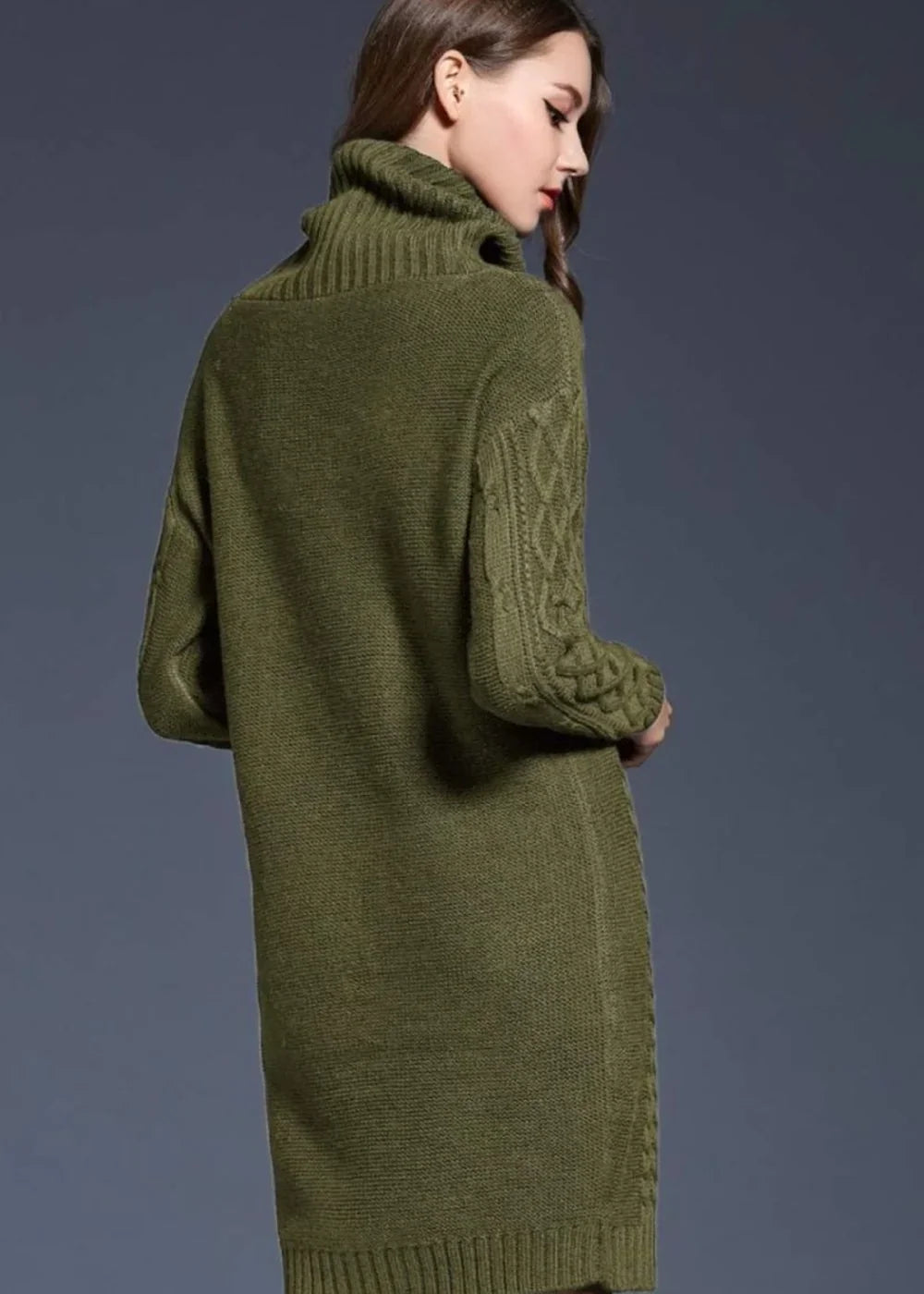 Green knit sweater dress with a turtleneck and cable knit sleeves, shown from the back on a model.
