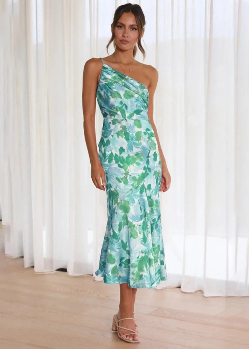 Flowy one-shoulder midi dress with a vibrant green and blue floral print.