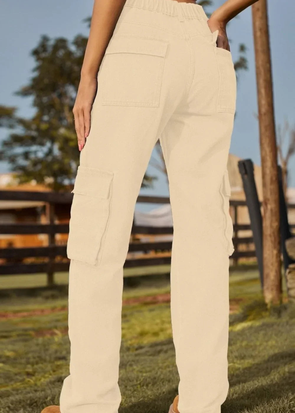 Cream cargo pants with multiple pockets, shown from the back, with a relaxed fit and textured fabric.