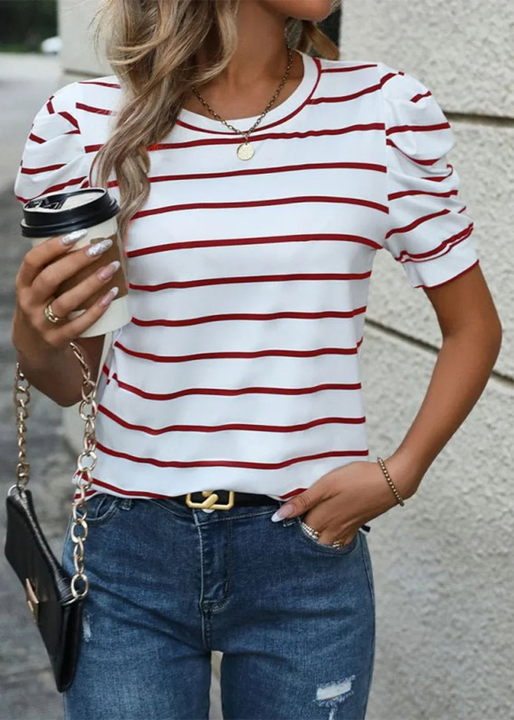 White and red striped puff-sleeve top with gold necklace and chain purse.