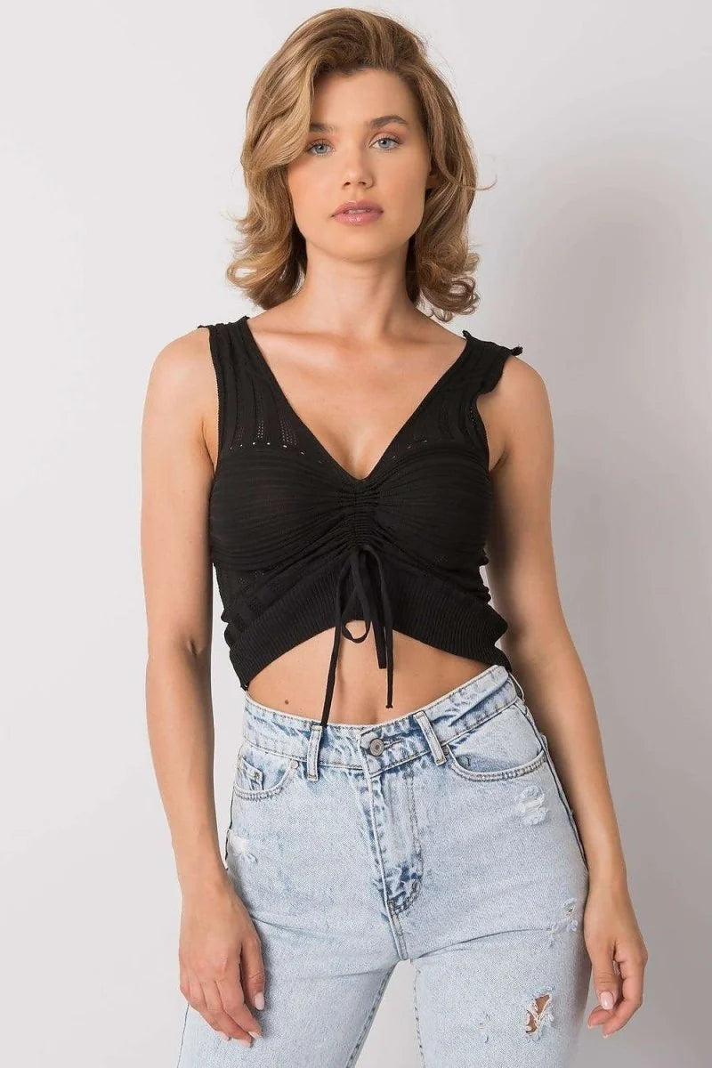 Black ruched v-neck acrylic crop top with tie detail, on model wearing light wash ripped jeans