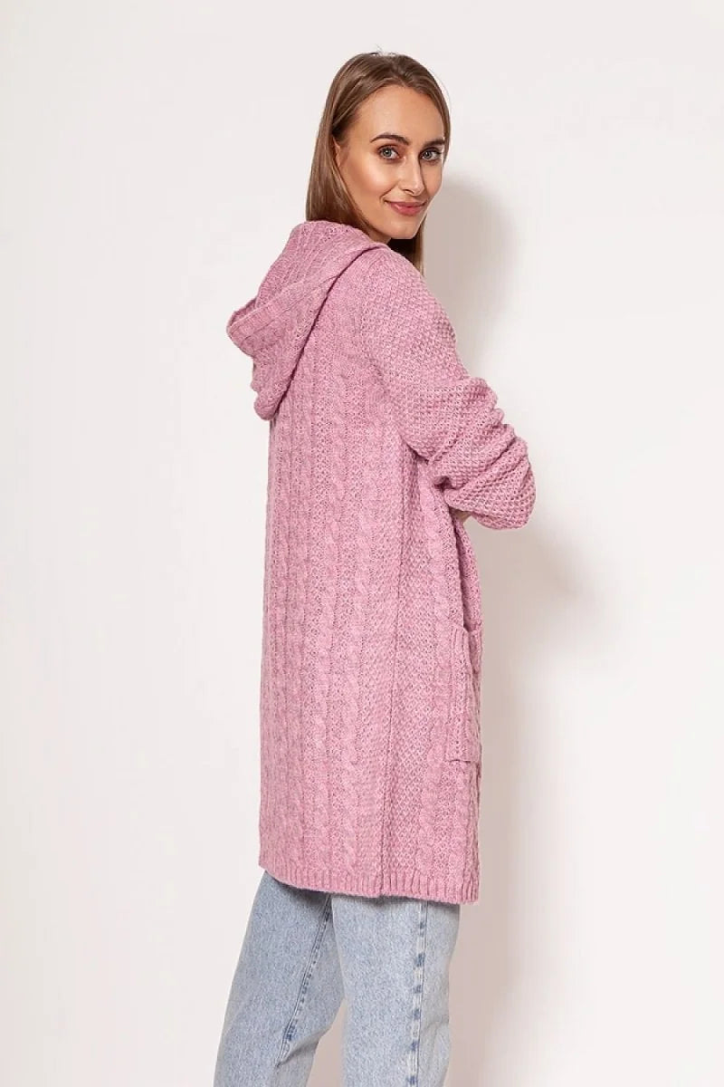 Pink cable knit hooded cardigan with pockets, on a model wearing light wash jeans.