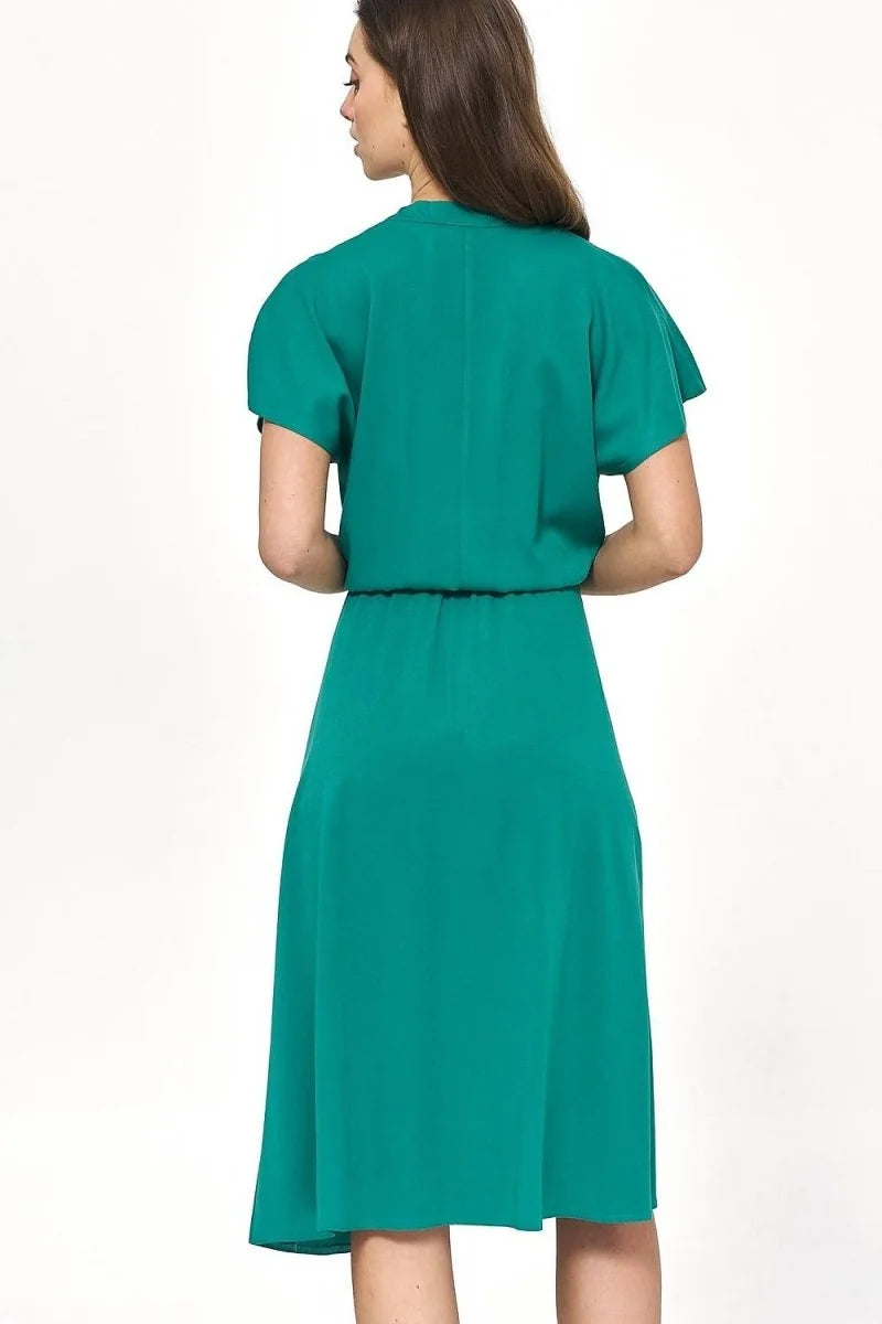 Back view of a teal green viscose dress with short sleeves and a cinched waist on a model.