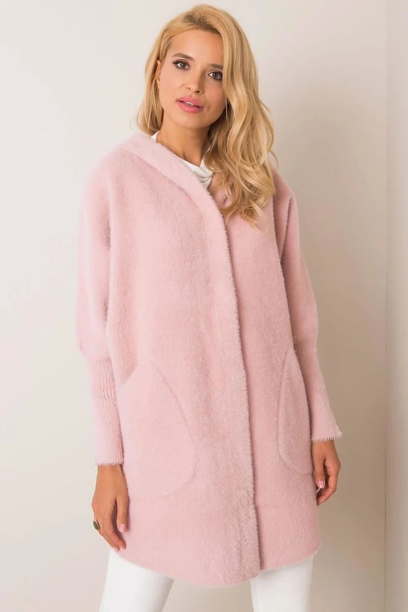 Soft pink angora blend cardigan with pockets and a relaxed fit, shown on a model.