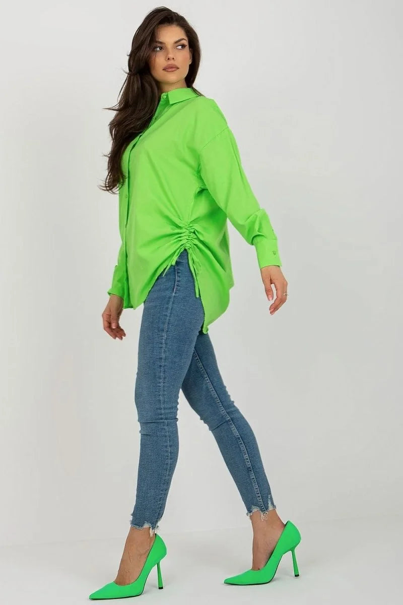 Lime green ruched button-up shirt with frayed hem jeans and matching heels on a model.