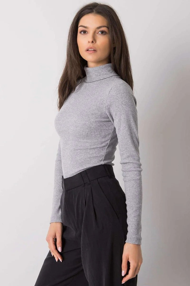 Light gray ribbed turtleneck top with long sleeves, fitted on a model.