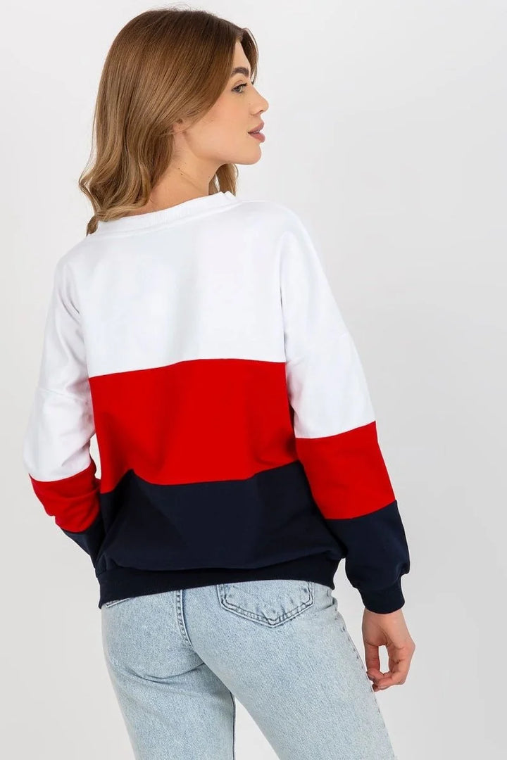 Colorblock sweatshirt with white, red, and navy blue panels, shown on a model.