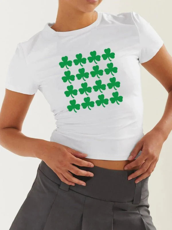 White fitted t-shirt with a repeating pattern of green shamrocks.