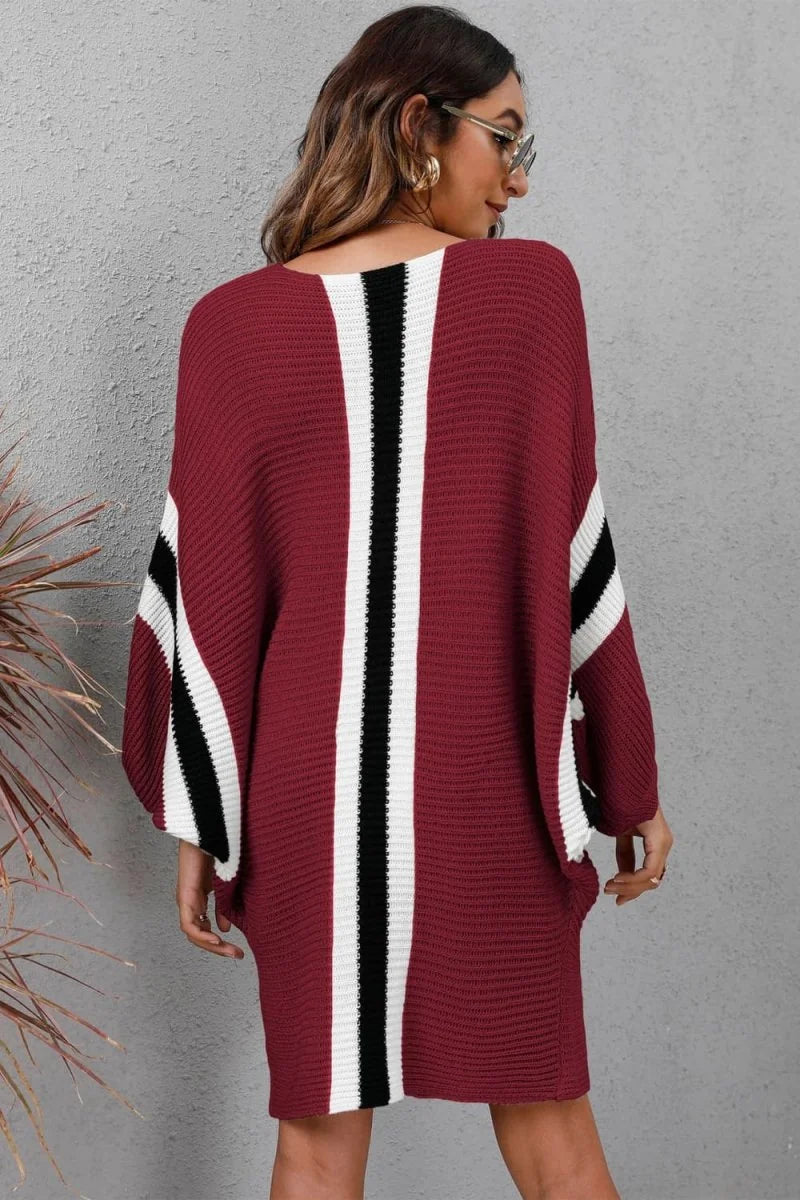 Burgundy acrylic sweater dress with bold black and white vertical stripes on sleeves and back.