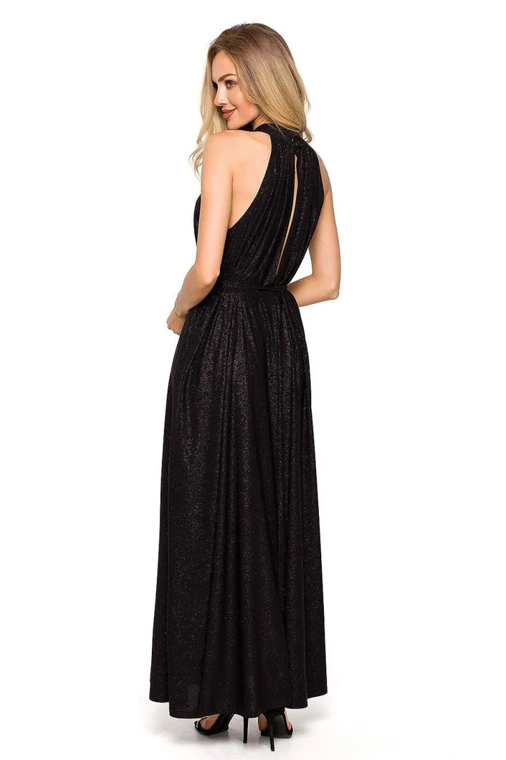 Black sparkly floor-length dress with a high neckline and open back, worn by a model.