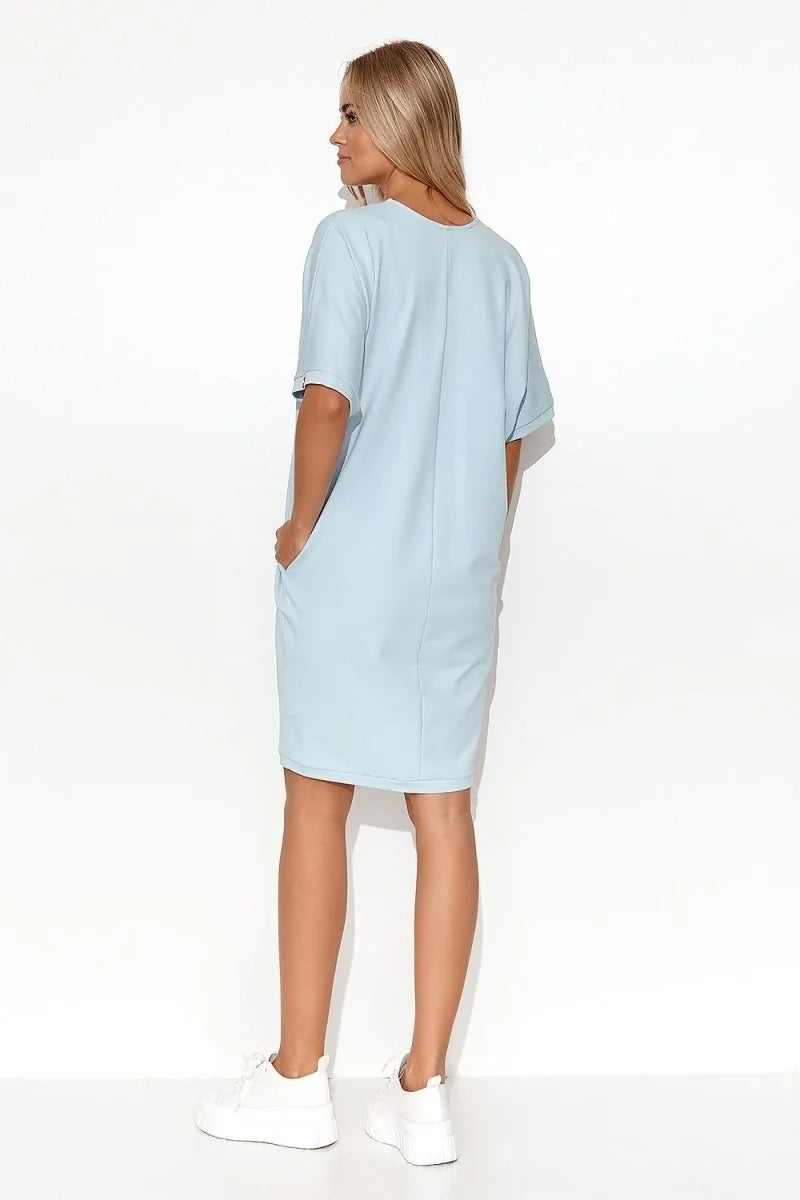 Light blue short-sleeve cotton-blend dress with pockets, worn by a model from the back.