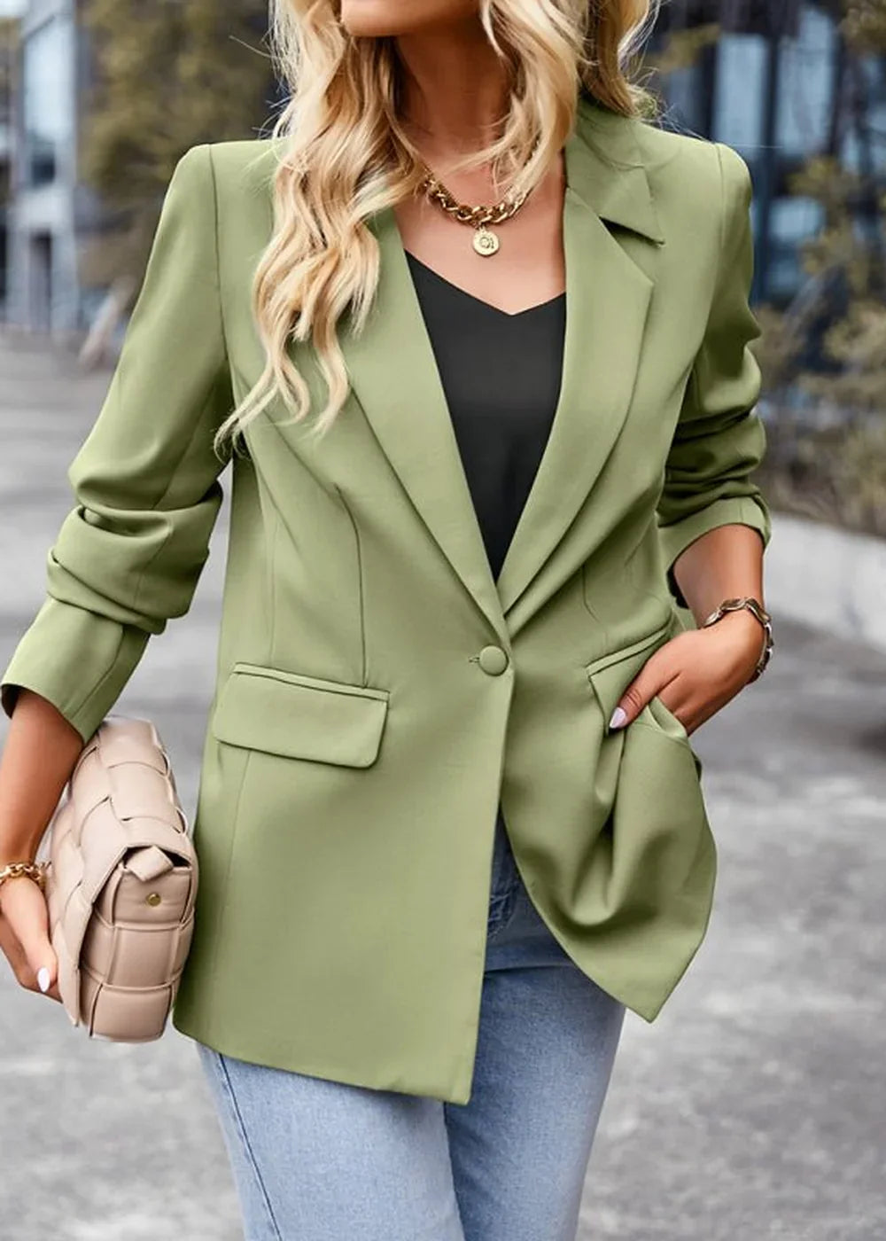 Light green polyester blazer with a single button closure, on model.