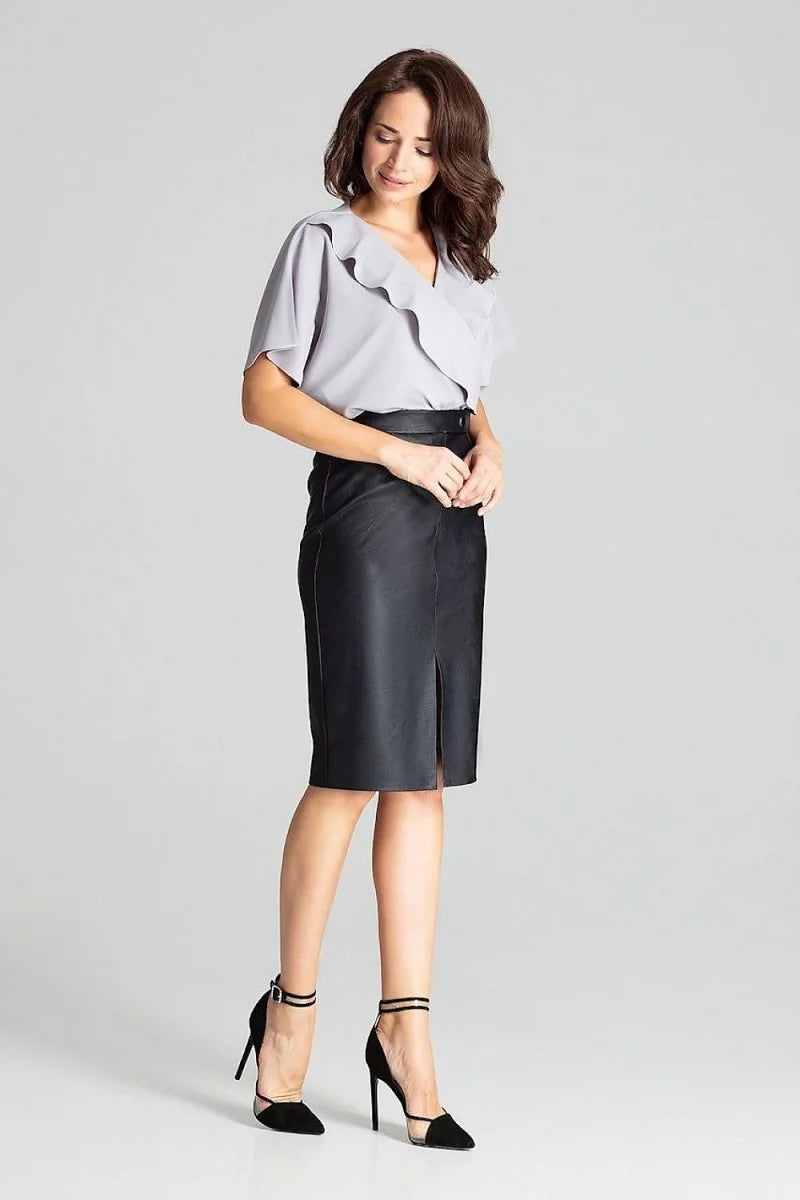 Black faux leather pencil skirt with a front slit, on a model.