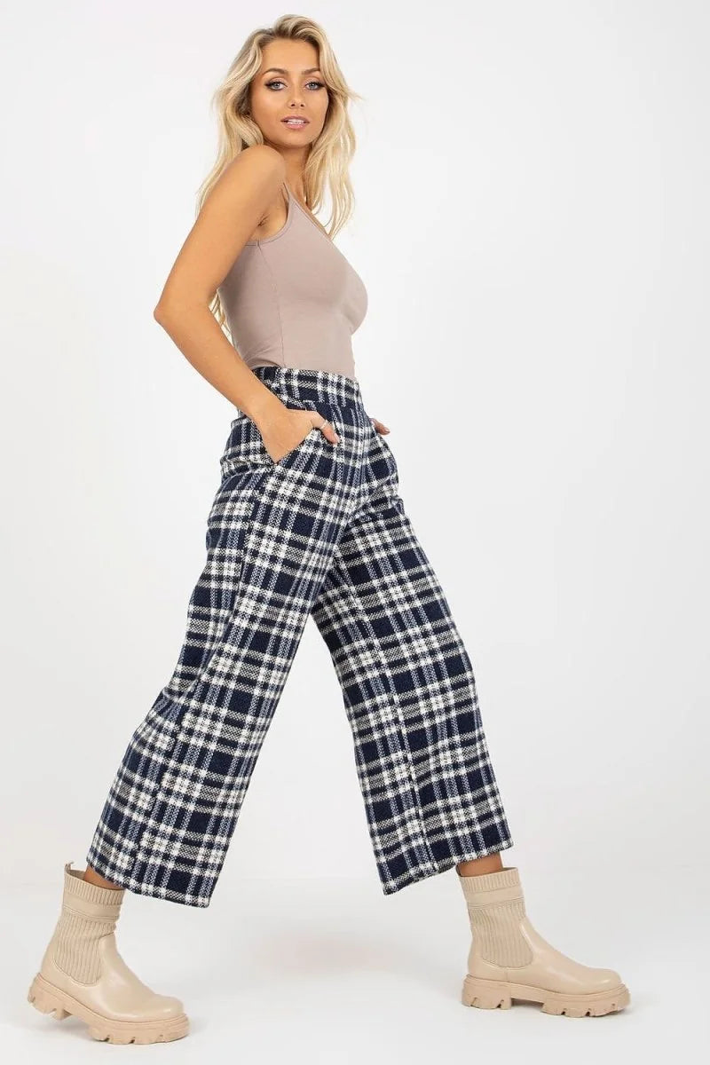Navy blue and white checkered wool pants with a regular fit, worn by a model.
