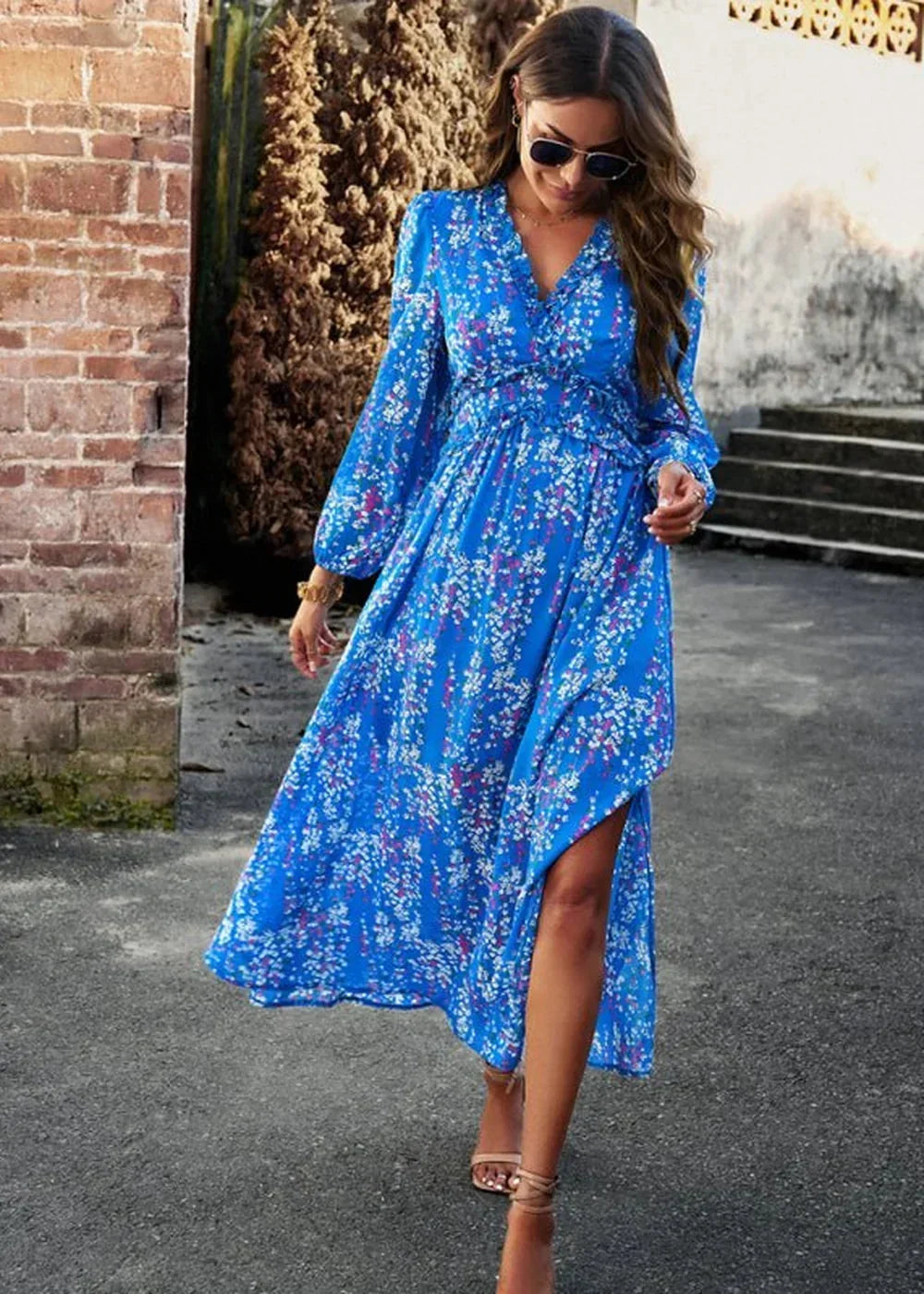 Blue floral print midi dress with long sleeves and a V-neck, shown on a model.