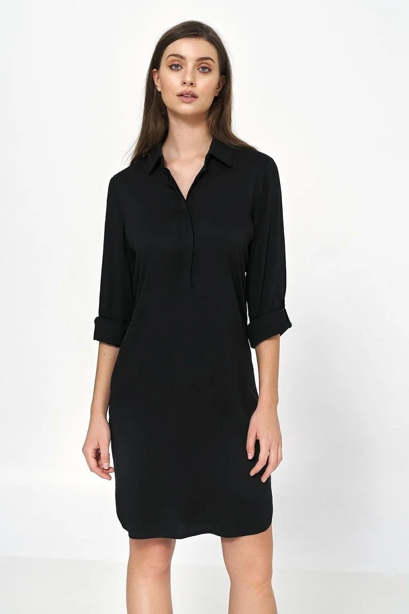 Oversized black viscose shirt dress with rolled sleeves, shown on a model.