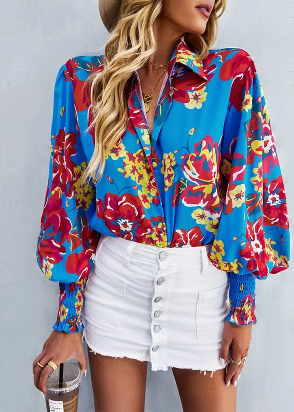 Blue floral print long-sleeve shirt with gathered cuffs, paired with a white button-front denim skirt.