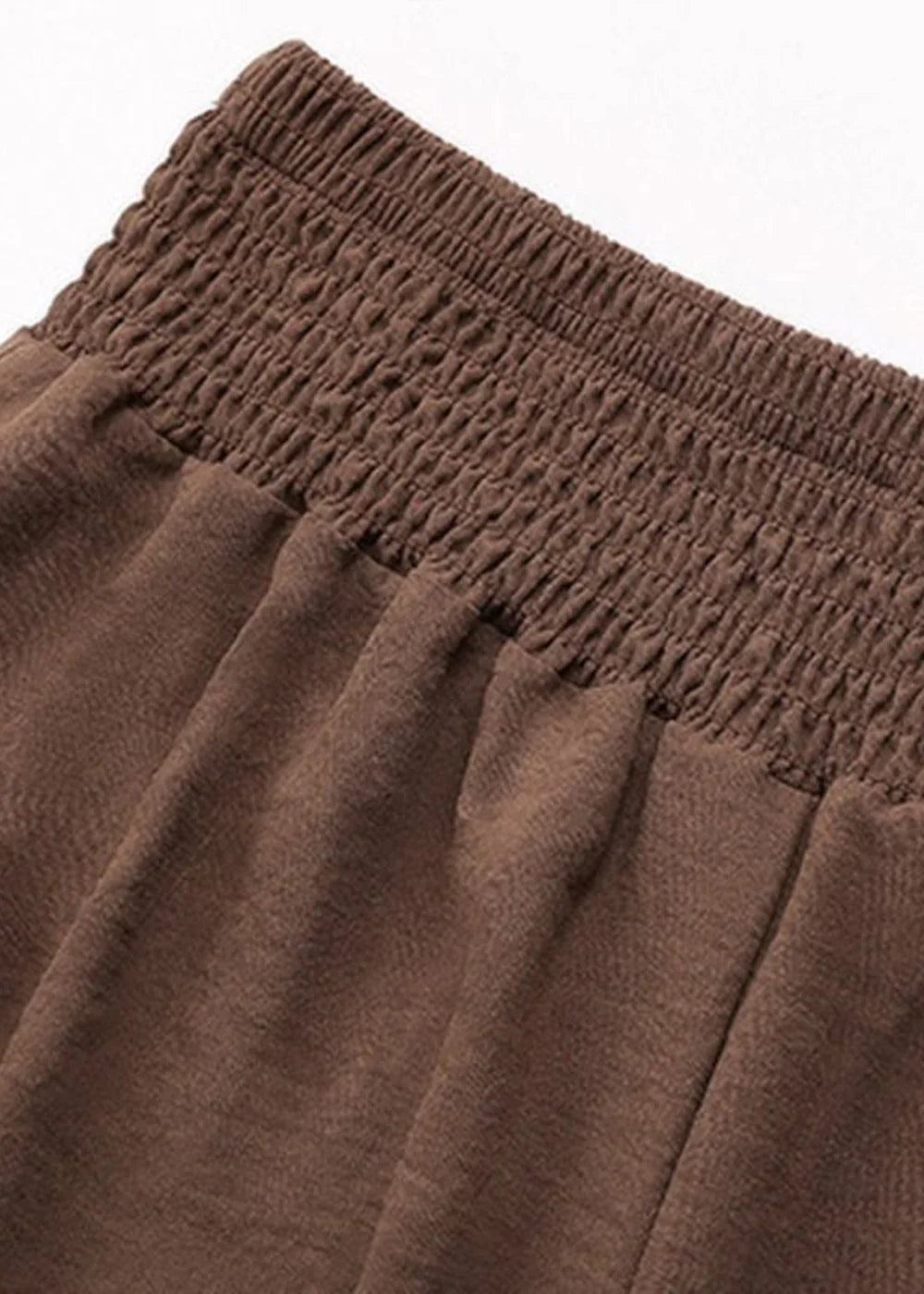 Close-up of brown bottoms showing gathered elastic waistband and soft, textured fabric.