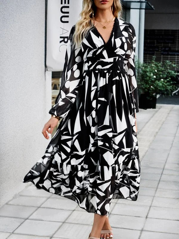 Black and white abstract print maxi dress with long sleeves and a tiered ruffled skirt.