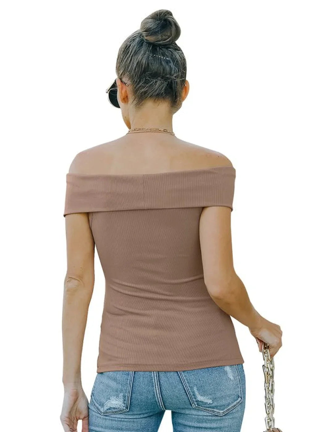 Woman from behind wearing a brown ribbed off-the-shoulder top and distressed jeans.