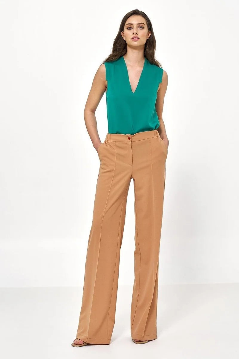 Tan wide-leg pants with a relaxed fit and subtle front seams, shown on a model.