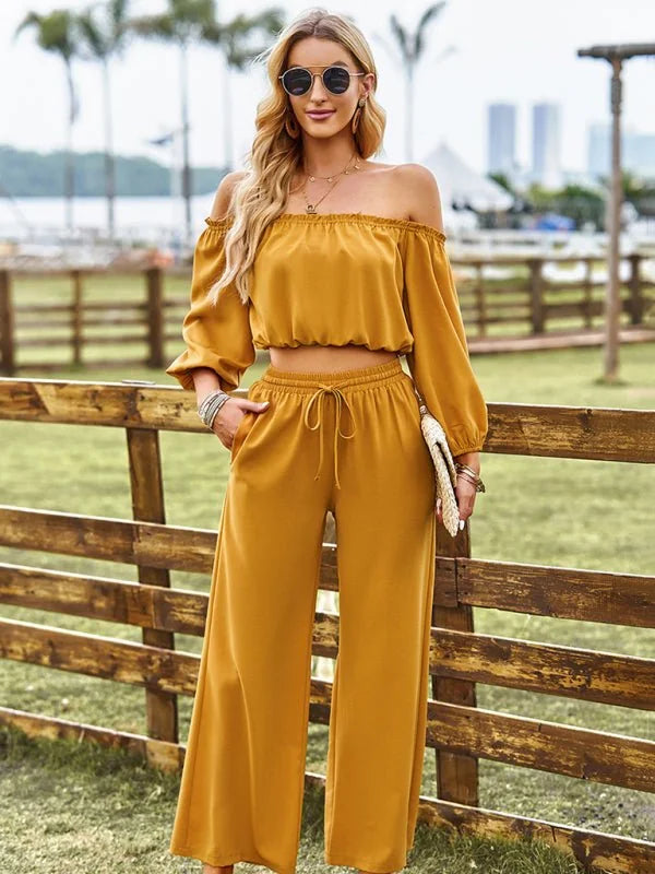 Mustard yellow off-the-shoulder crop top and wide-leg pants set on a model.