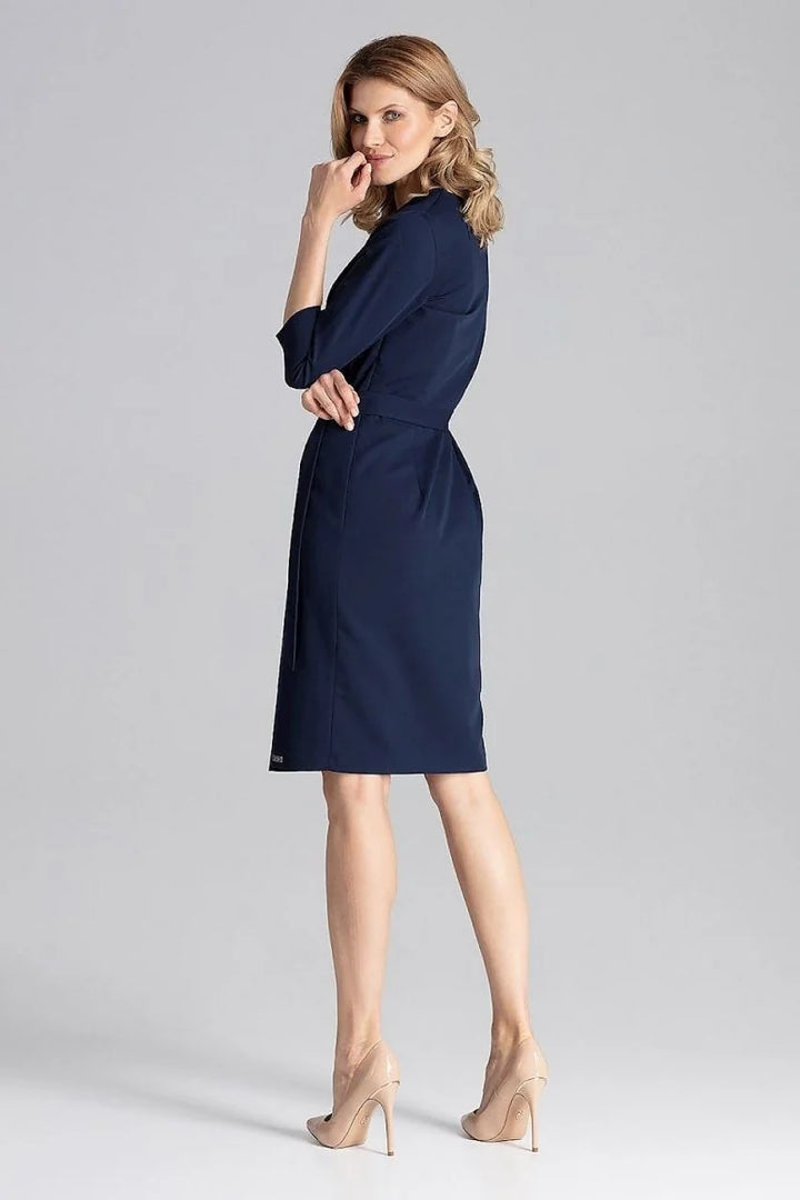 Navy blue dress with tie waist and 3/4 sleeves on a model wearing nude heels.