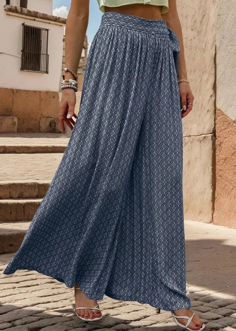 Flowy navy blue palazzo pants with a white geometric print and tie waist.