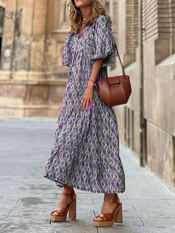 Purple and lime green geometric print midi dress with ruffled tiers and brown platform heels.