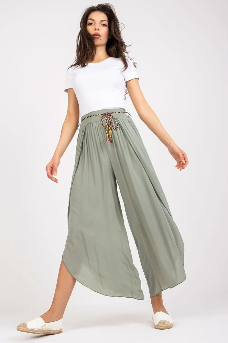 Sage green wide-leg viscose pants with a decorative braided belt and white espadrilles.