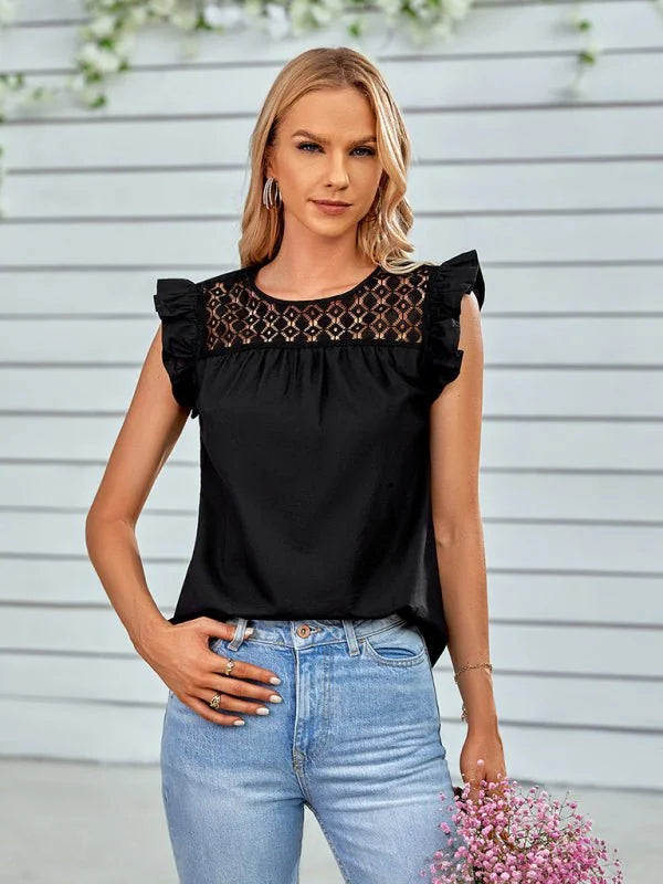 Black ruffled sleeve top with lace yoke, paired with light wash jeans.