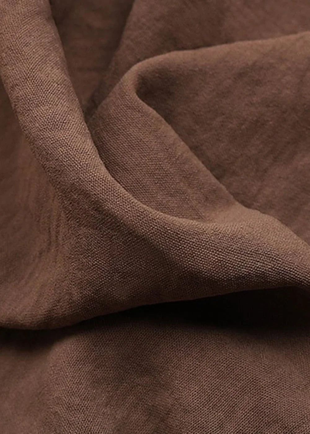 Close-up of textured brown polyester and elastane fabric with subtle weave detail.