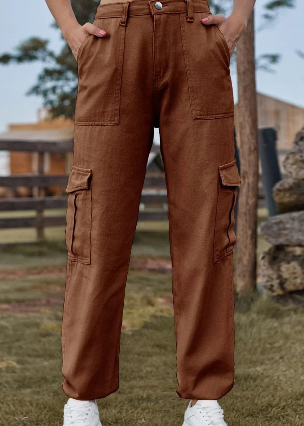 Brown cargo pants with multiple pockets, regular fit, on model with white sneakers.