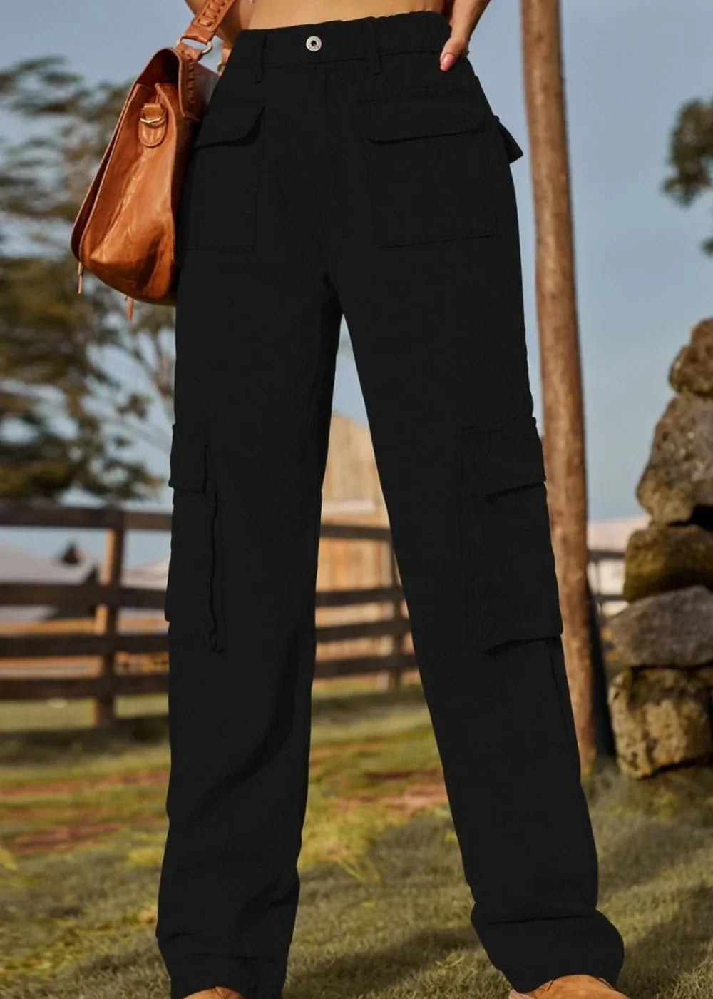 Black cargo pants with multiple pockets and a drawstring detail, shown on a model.