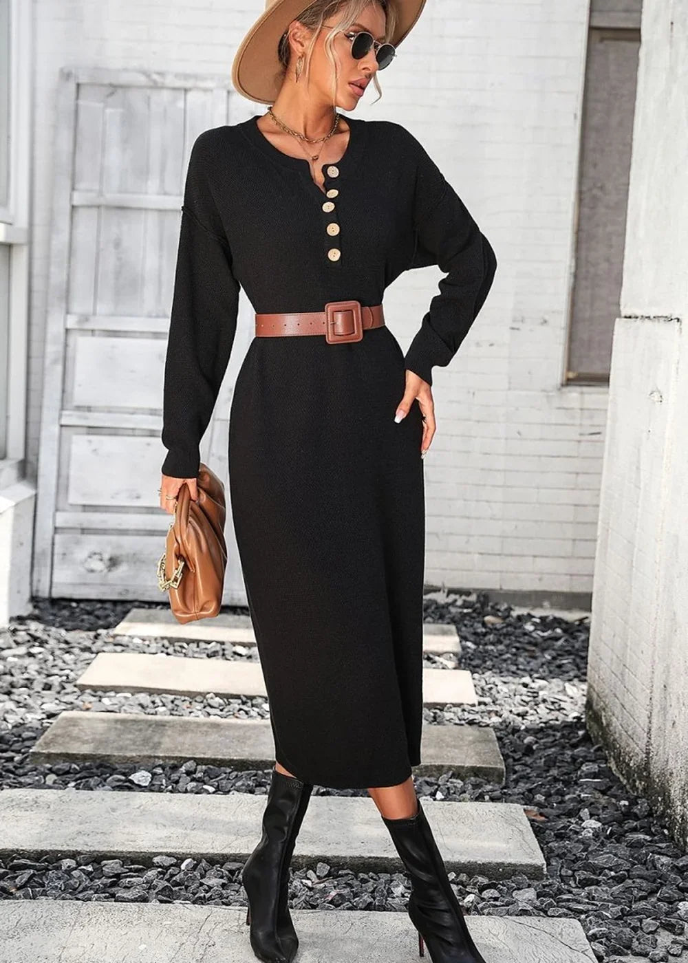 Black ribbed knit midi dress with button detail, brown belt, and black boots on model.