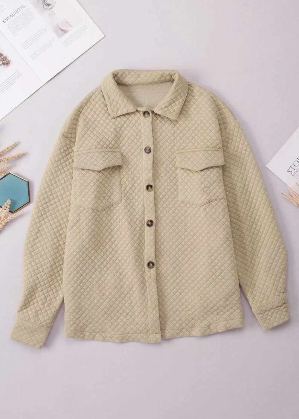 Quilted beige shacket with button-front closure and chest pockets.
