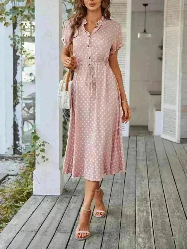 Light pink rayon polka dot midi dress with drawstring waist and button front, worn by model.