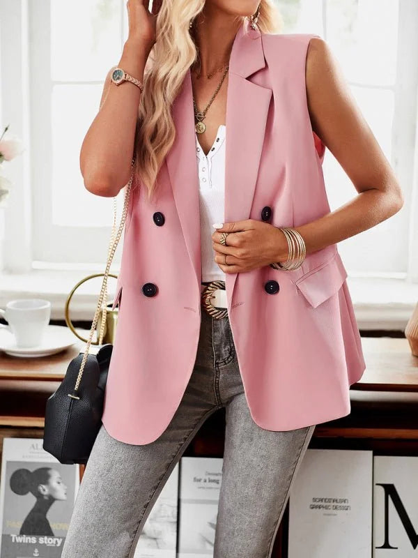 Pink sleeveless blazer with double-breasted buttons and a lapel collar on a model.