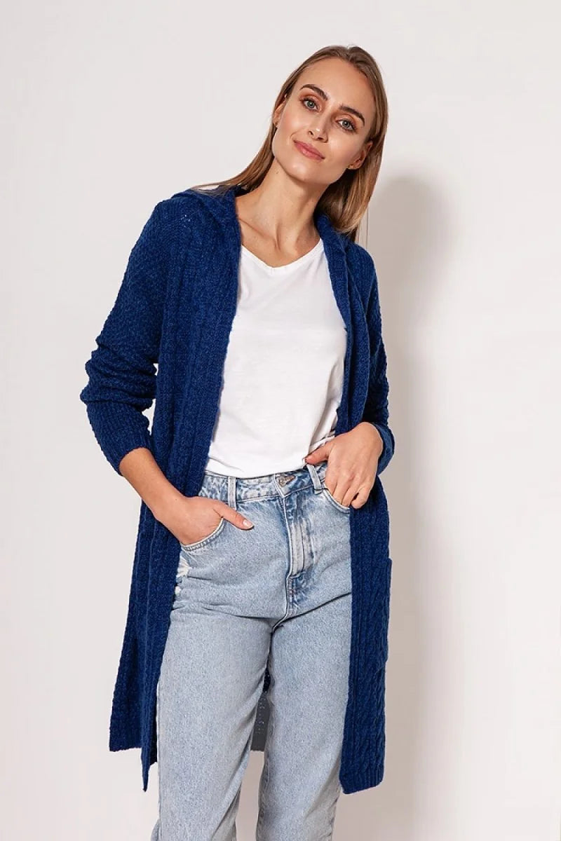 Navy blue hooded cable knit cardigan with pockets, worn by a model with light wash jeans.