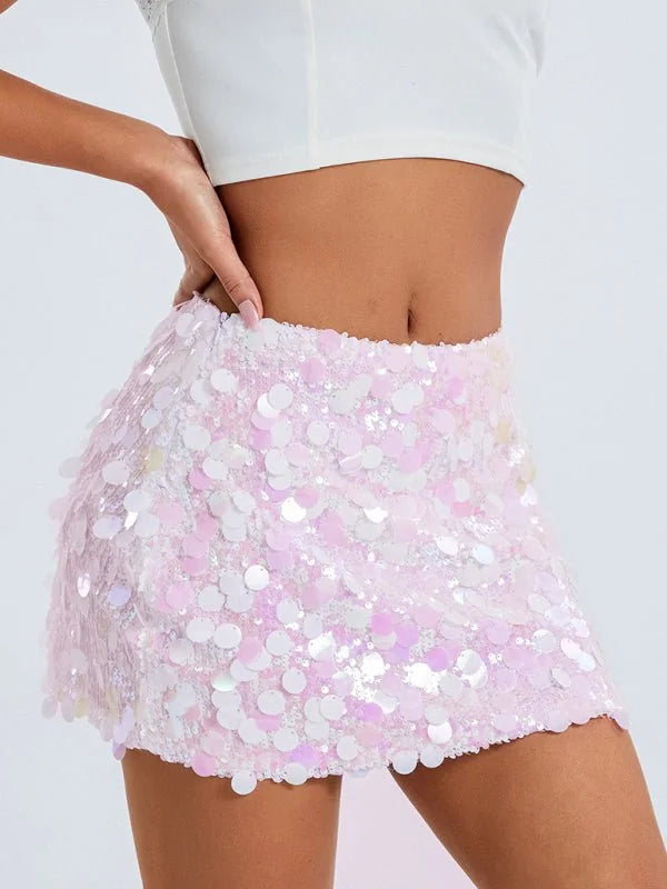 Pale pink sequin mini skirt with a textured, iridescent finish, shown on a model.