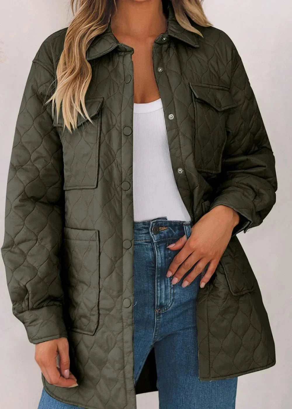 Khaki quilted jacket with snap closures and chest pockets on model.