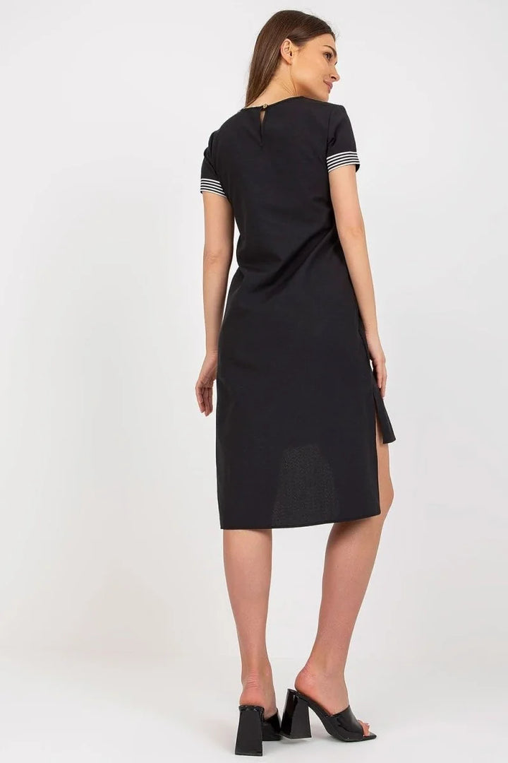 Black cotton dress with striped sleeve detail, side slit, and black block heel mules.