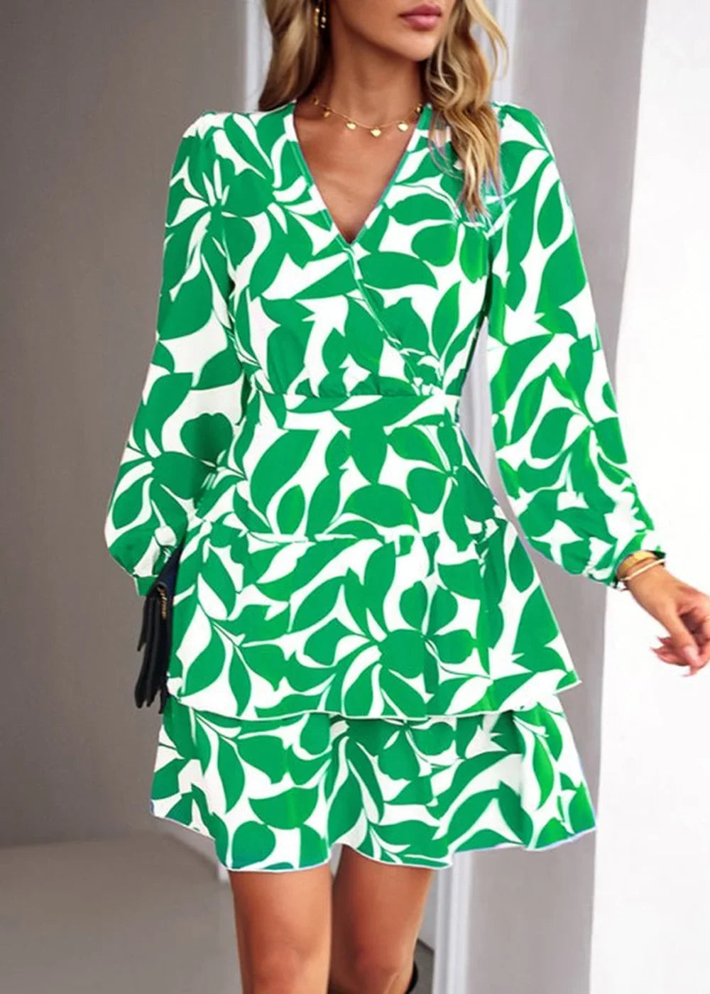 Green and white floral print wrap dress with tiered skirt and long sleeves.