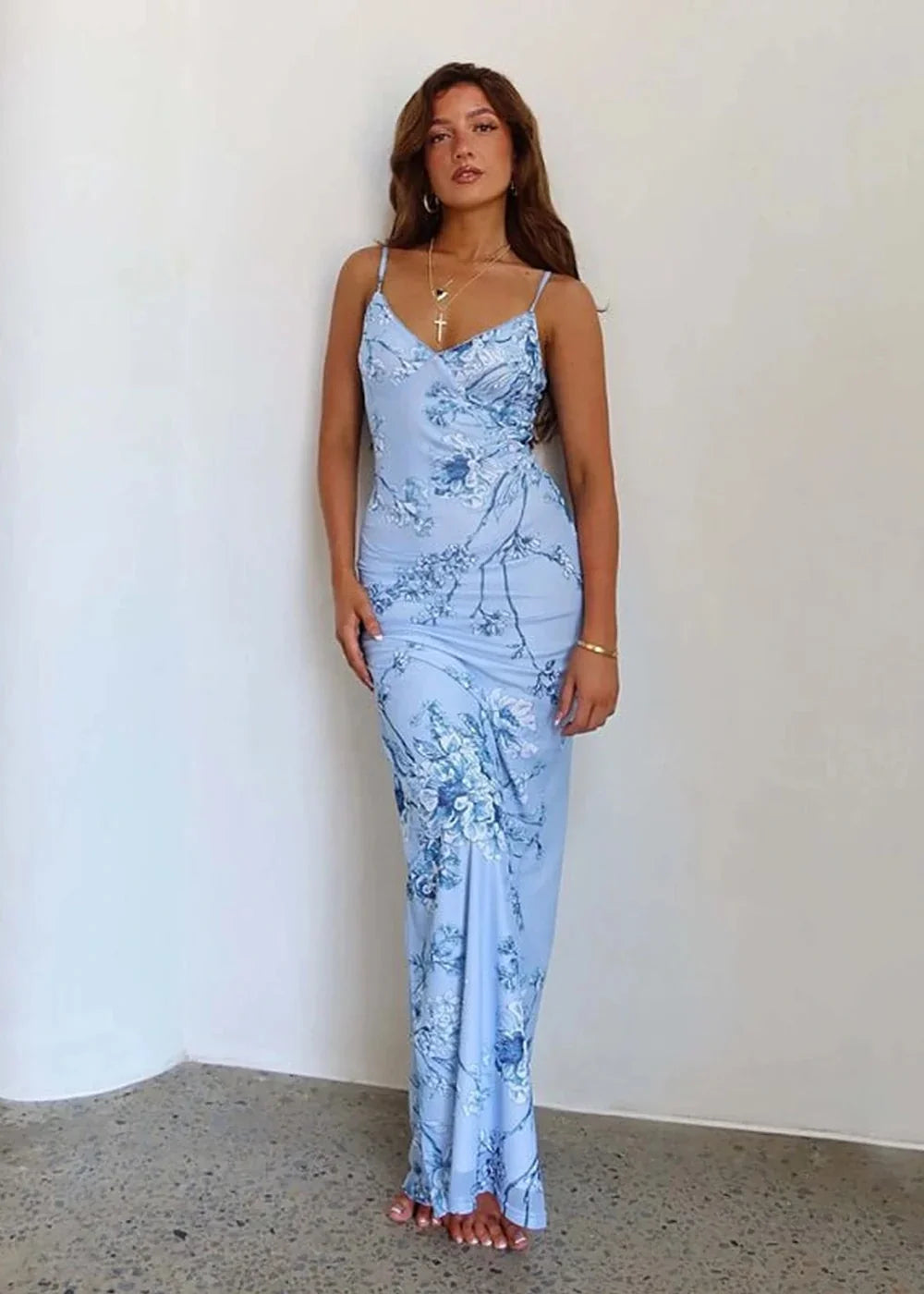 Light blue maxi dress with a delicate floral print, featuring a slim fit and a cowl neckline.