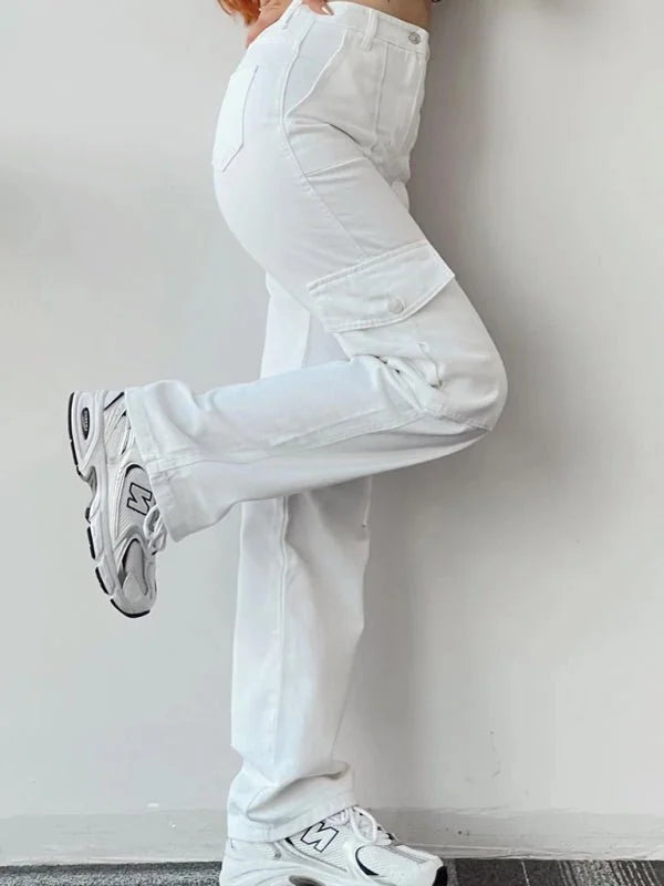 White relaxed-fit cargo pants with a button-flap pocket on the side, worn with white sneakers.