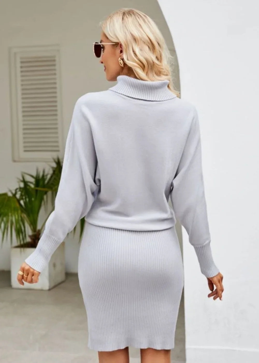 Light gray ribbed knit turtleneck sweater dress with dolman sleeves.