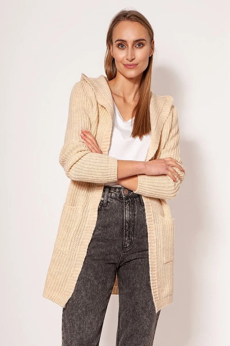 Cream-colored hooded knit cardigan with pockets, worn by a model over a white top and dark wash jeans.