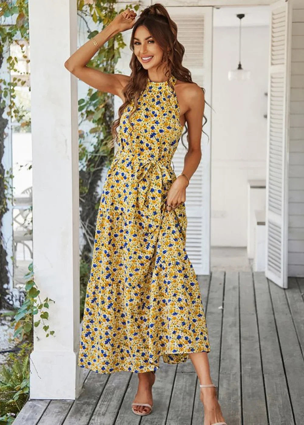 Yellow maxi dress with blue floral print, halter neckline, and tie waist.